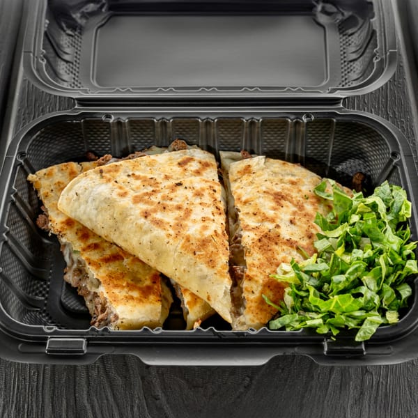 Sabor Tacos' quesadillas with melted cheese and meat, served with fresh shredded lettuce in a takeout container.